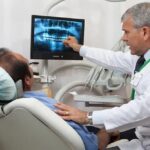 Dentist communicates with the patient in the dental chair